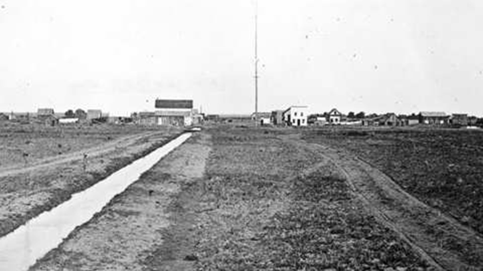 Old homesteads with a small irrigation ditch in 1870 in Greeley. 
