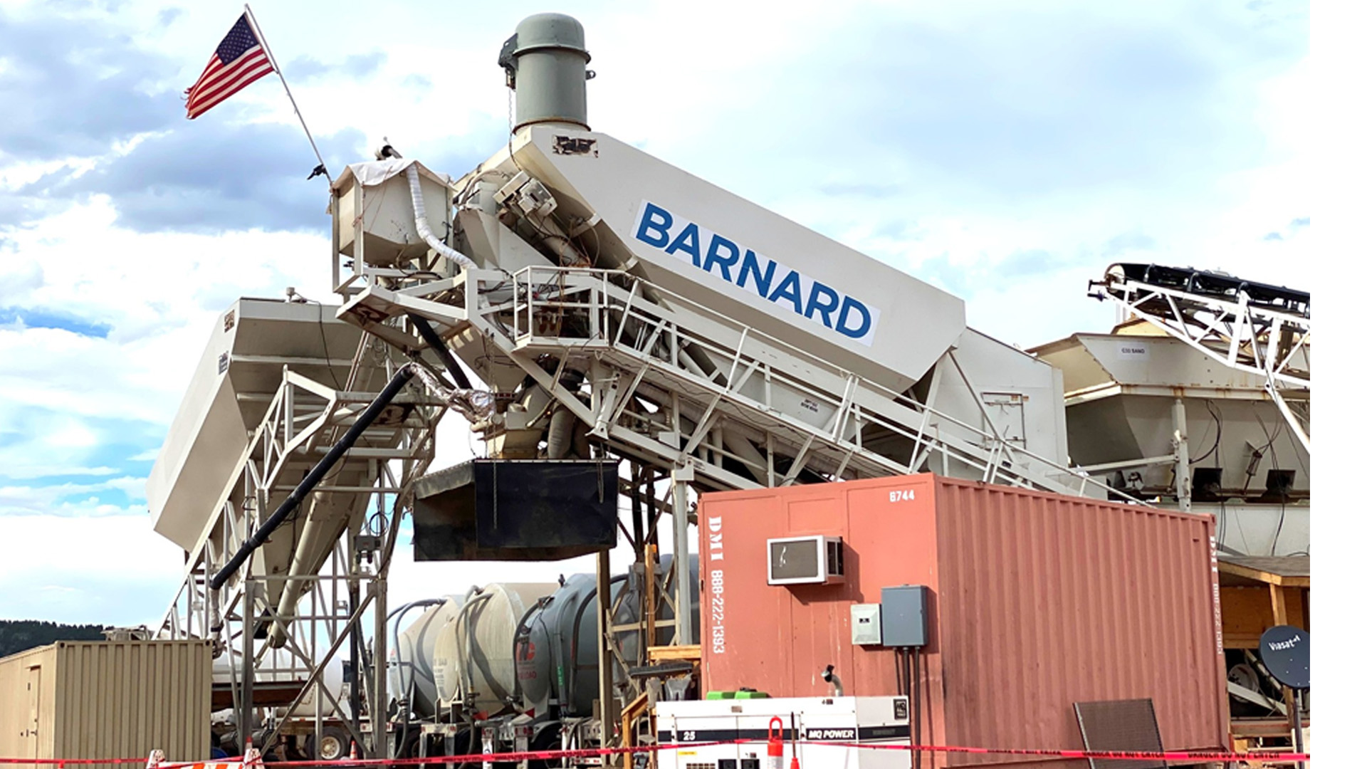 Barnard Construction's concrete batch plant with American flag waiving. 