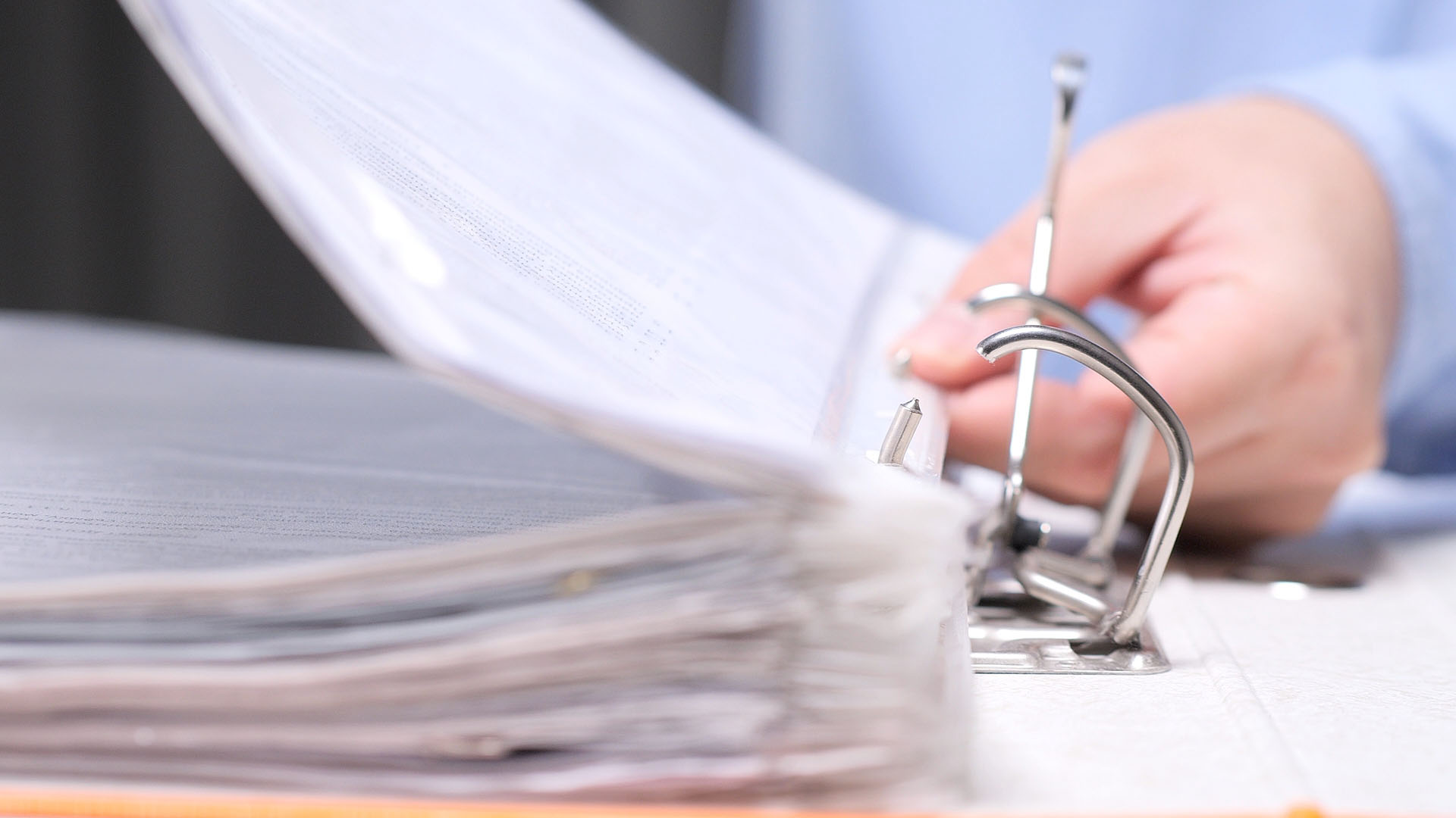 Stack of papers in a three ring binder.