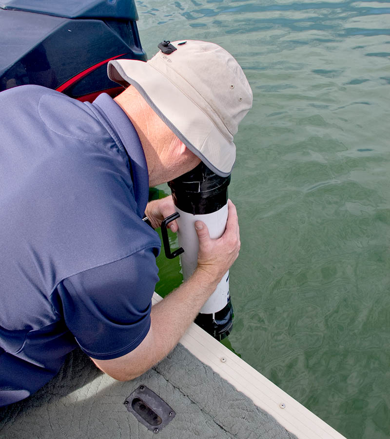 Man measuring secchi with viewscope.