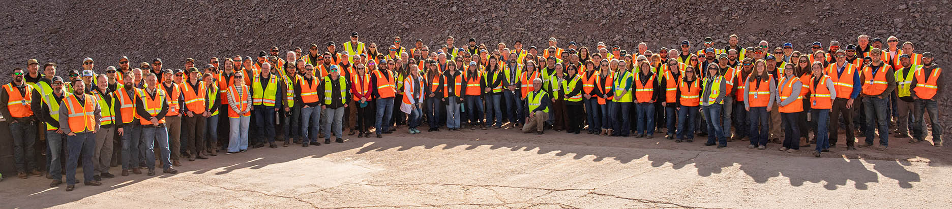 Group photo of employees in front of the Chimney Hollow dam.