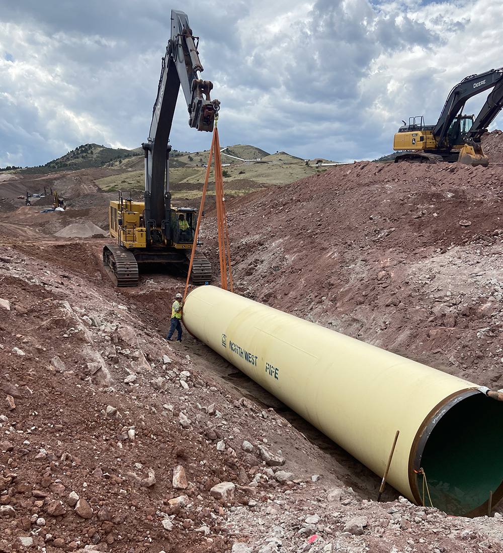 Crews placing the first 40-foot section of the Chimney Hollow Conduit.