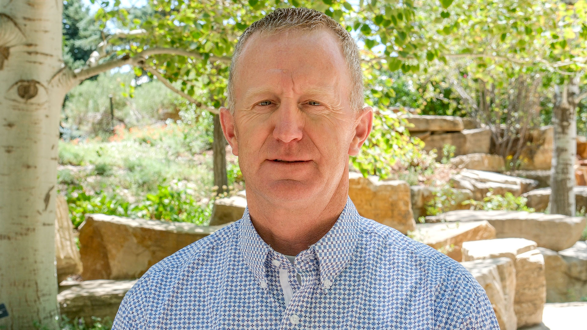 Man in a blue checkered button up shirt.