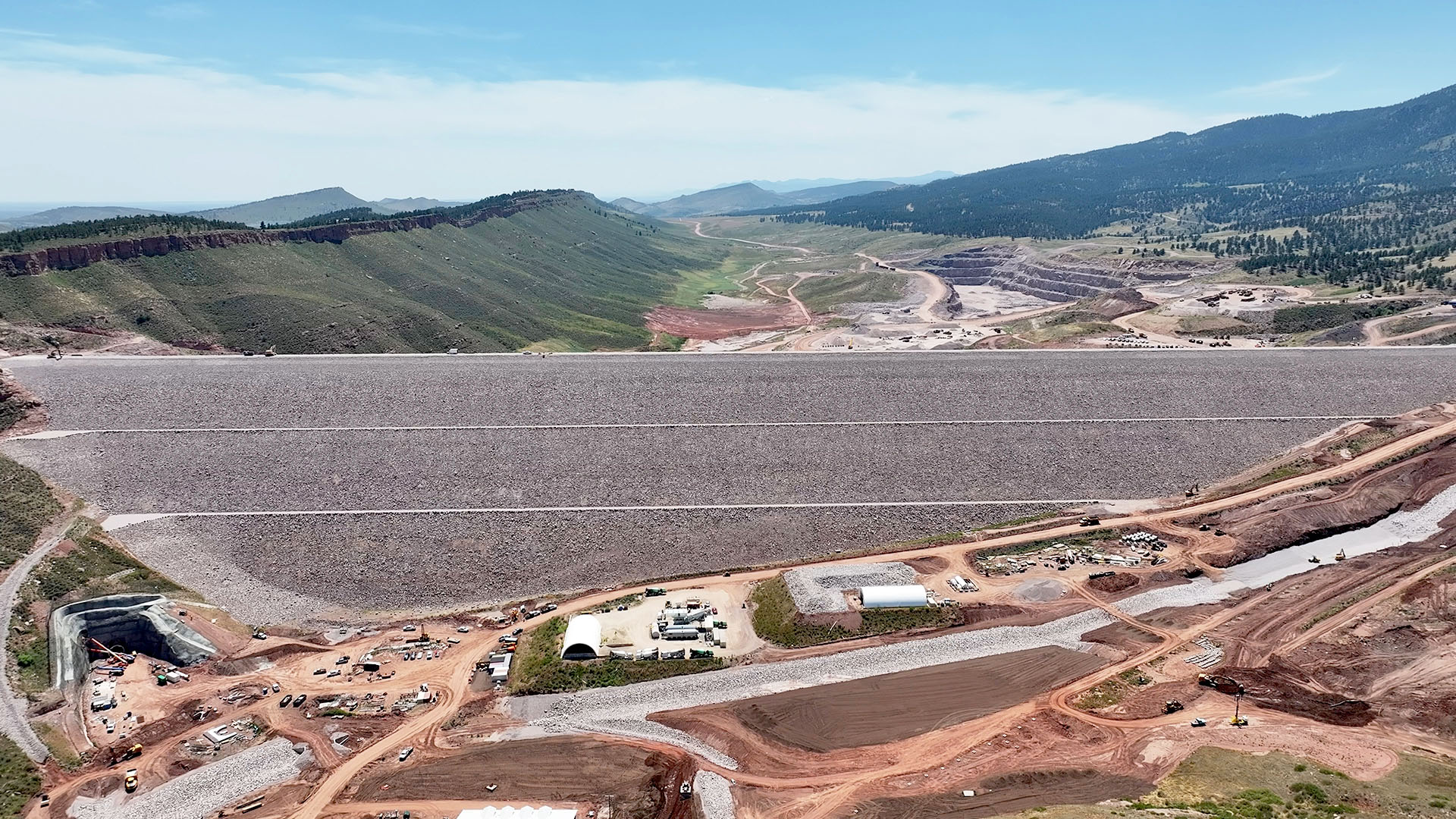 Main dam finished at Chimney Hollow with value house in foreground.