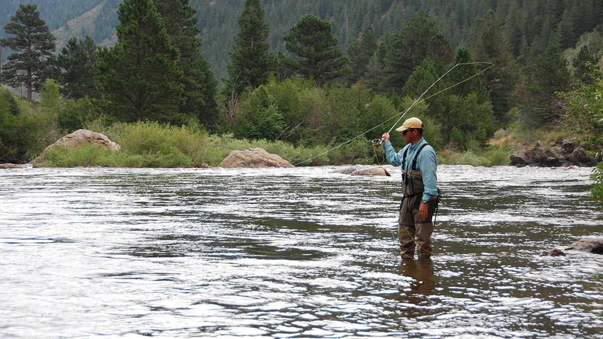 guy flyfishing in river