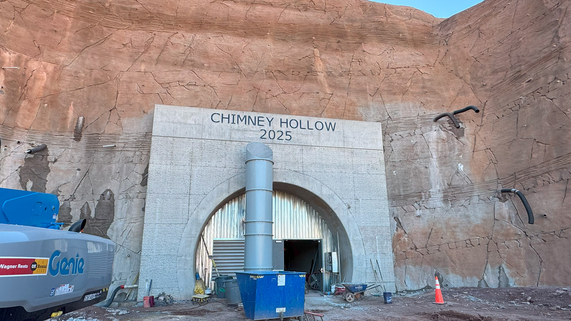 Entrance to a tunnel in the side of a mountain. 