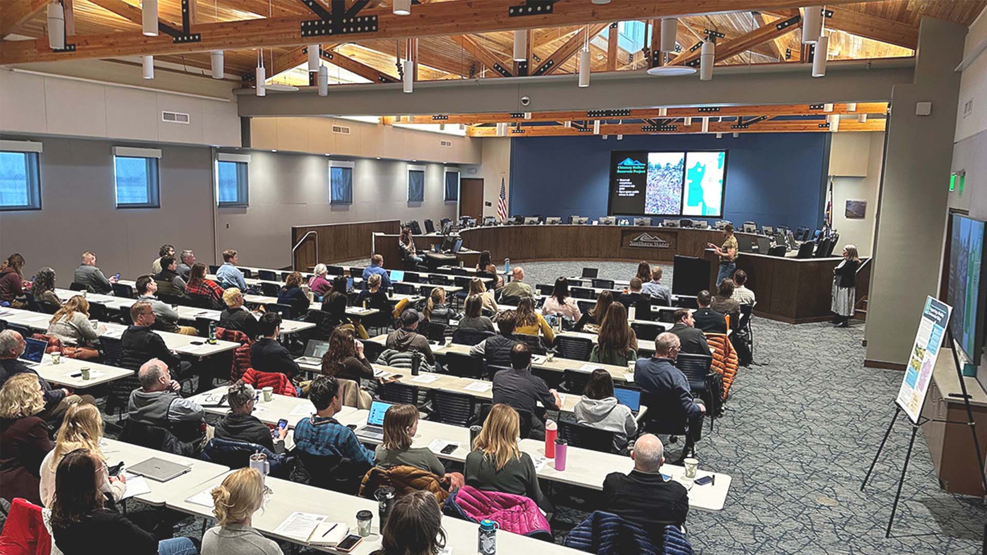 People in the board room listening to a presentation.