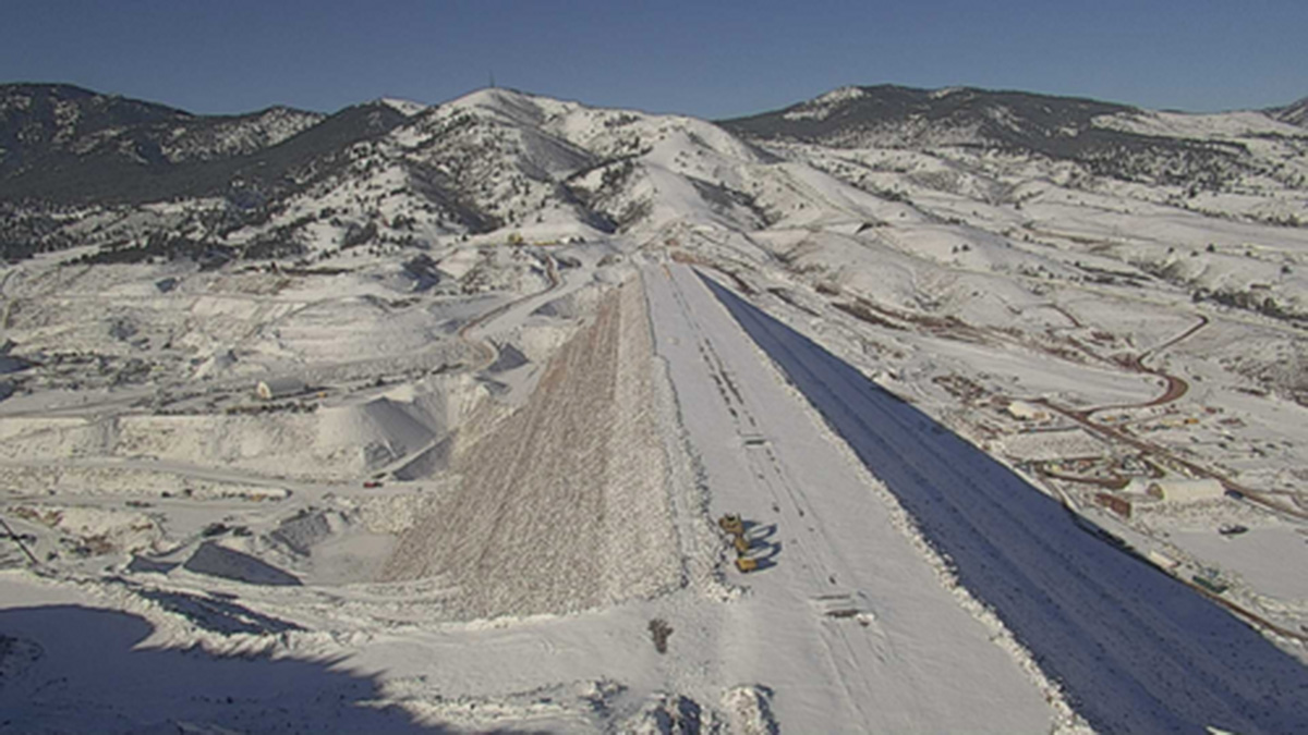 A snow-covered dam at Chimney Hollow Reservoir construction site