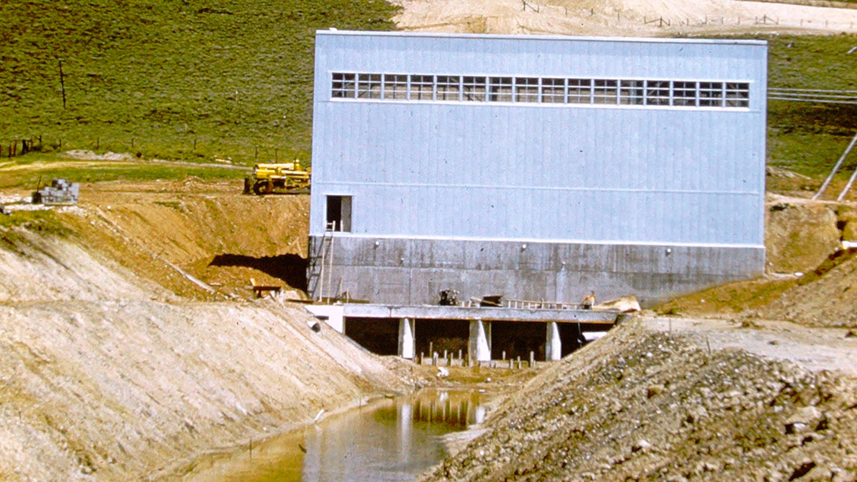 A structure sits above a canal with water flowing through it