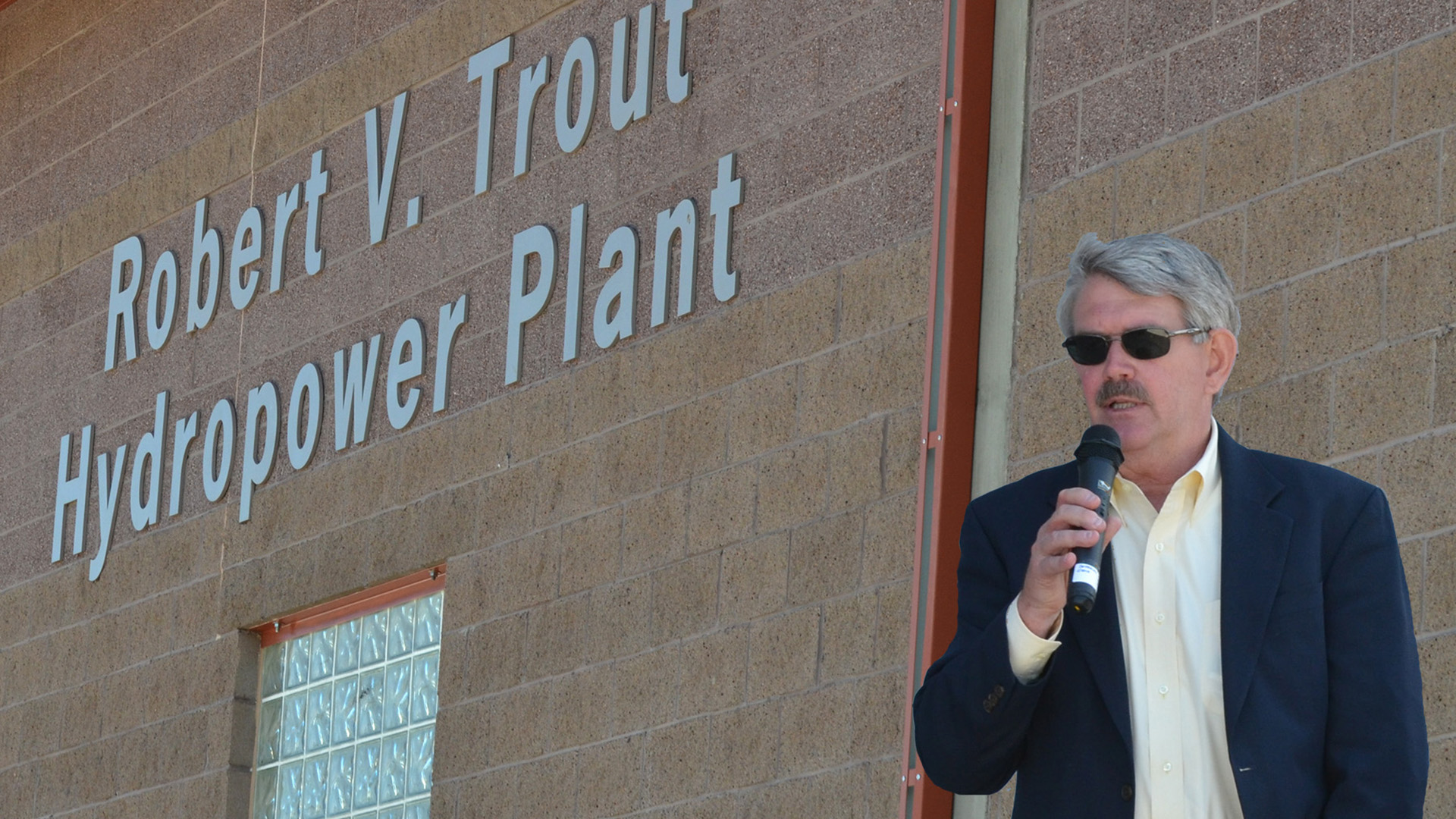 Man presenting outside of the Trout Hydropower Plant.