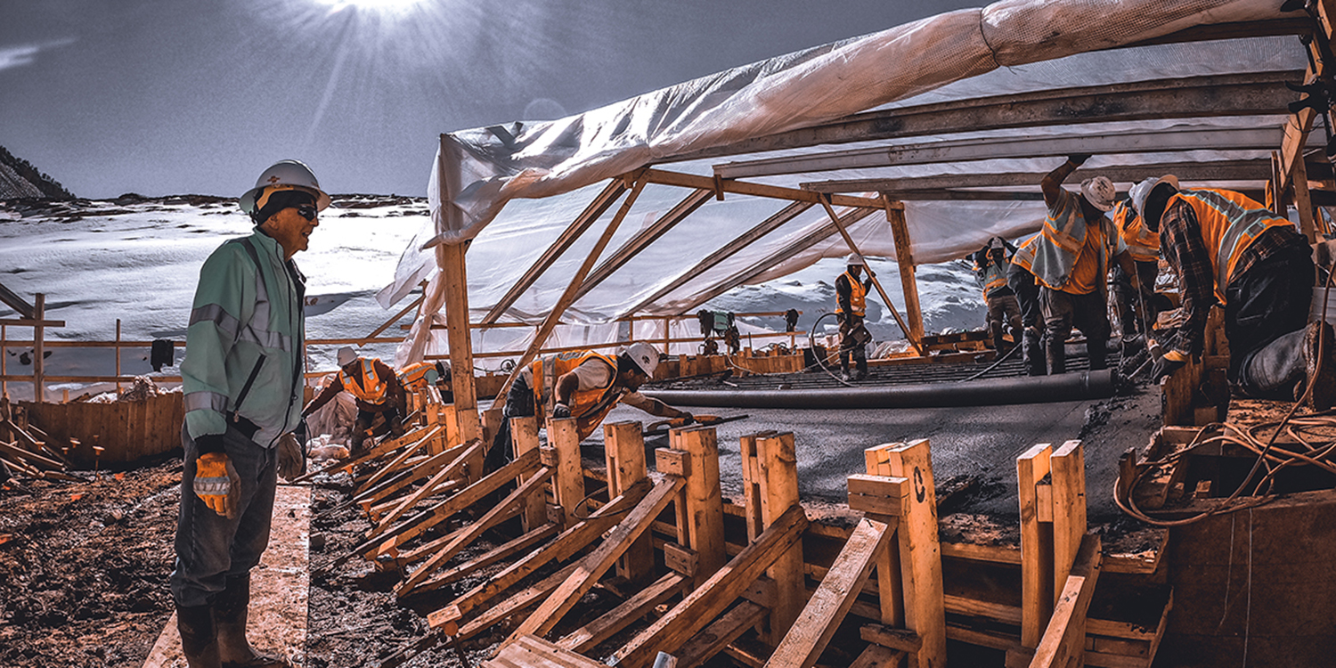 Crews working on the plinth under plastic during the cold, winter months. 