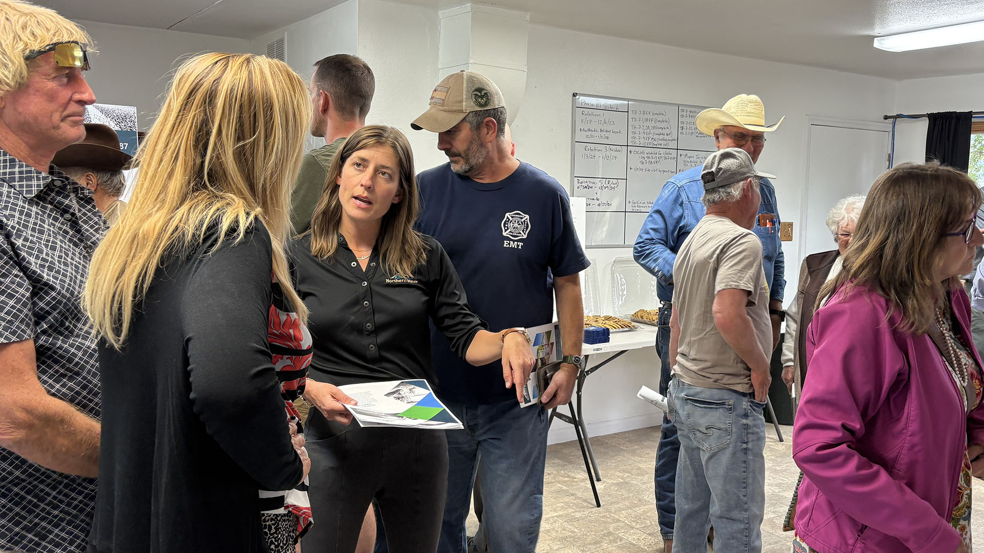 People talking at an open house for NISP.