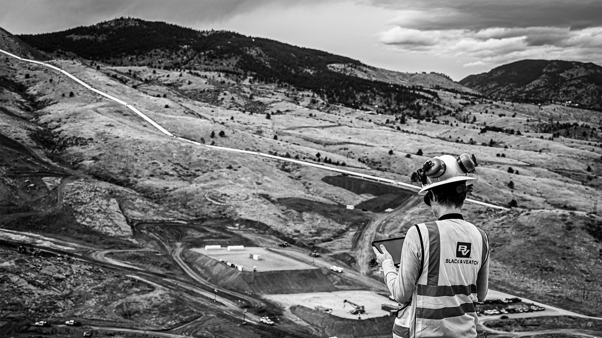 Quality insurance inspector overseeing work on the main dam at Chimney Hollow.