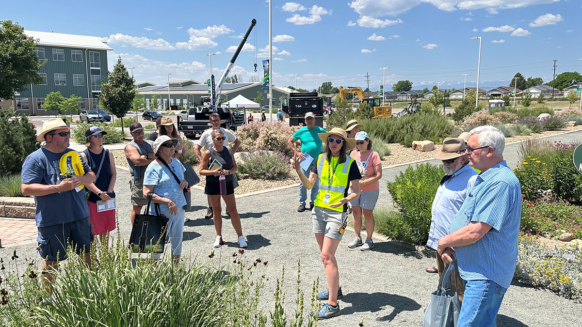 A tour guide in the center explaining the gardens and what to find. 
