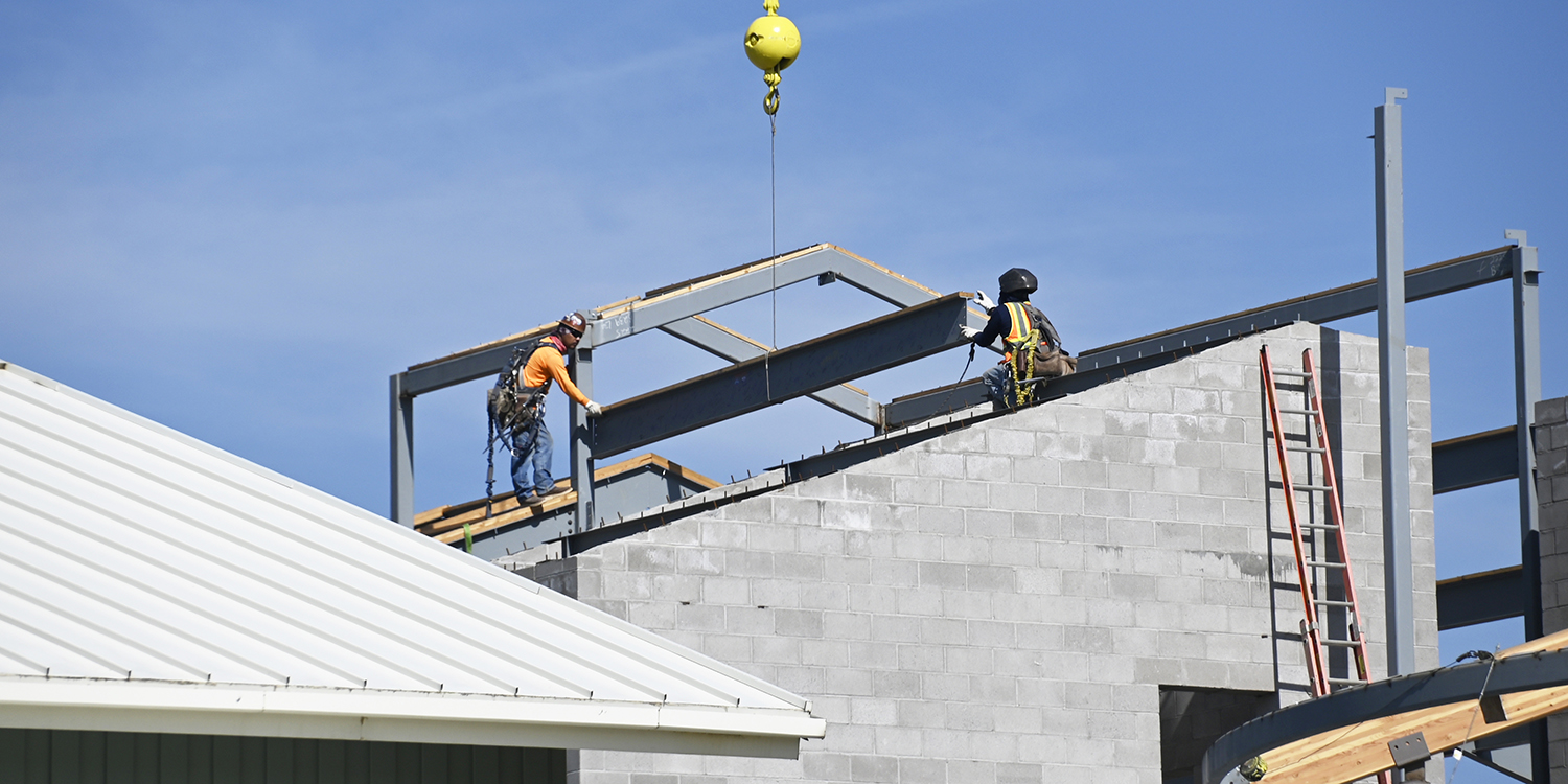 Building A topping out ceremony; lifting a beam in place