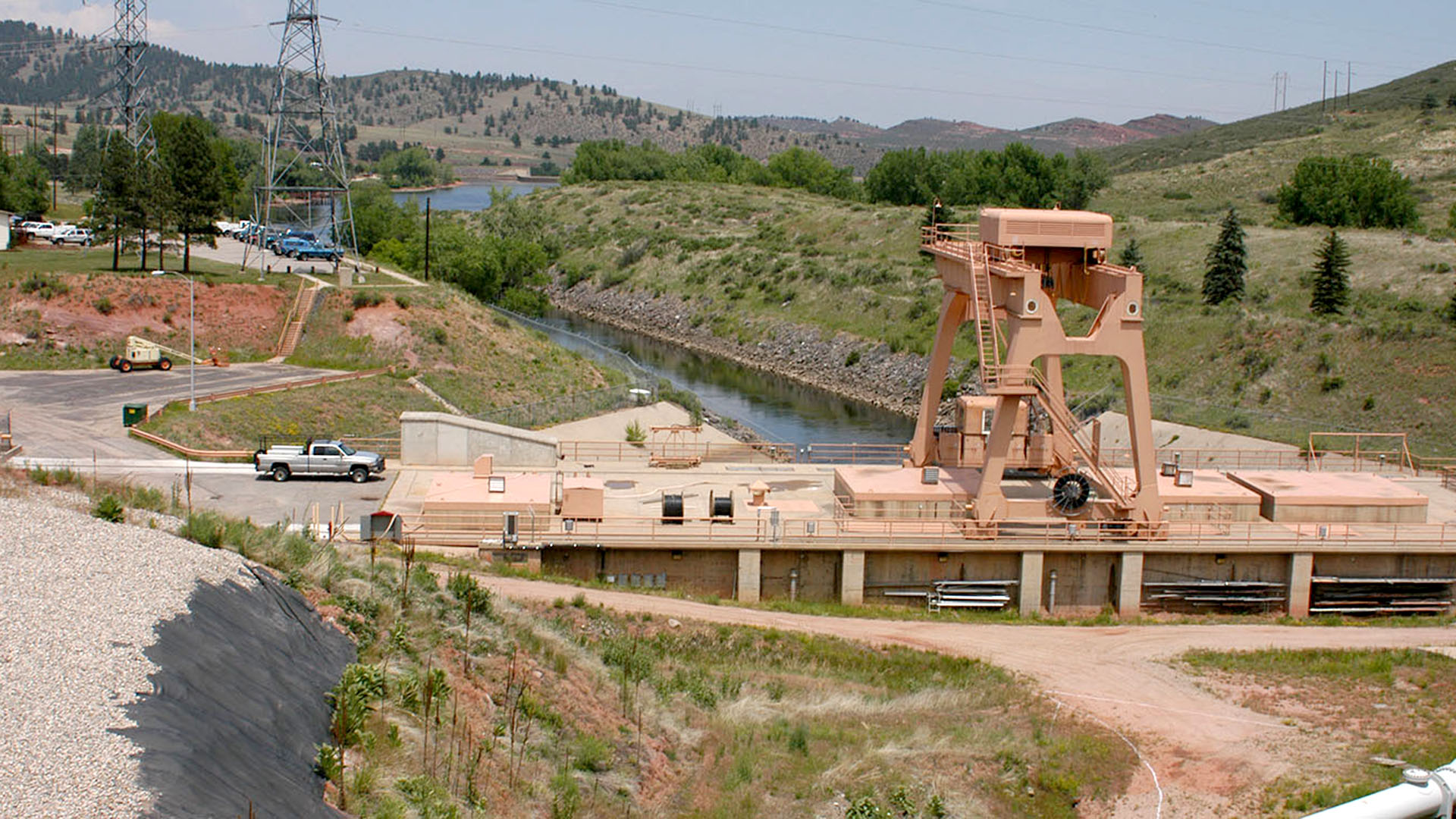 A water pump plant with water flowing out toward a reservoir.