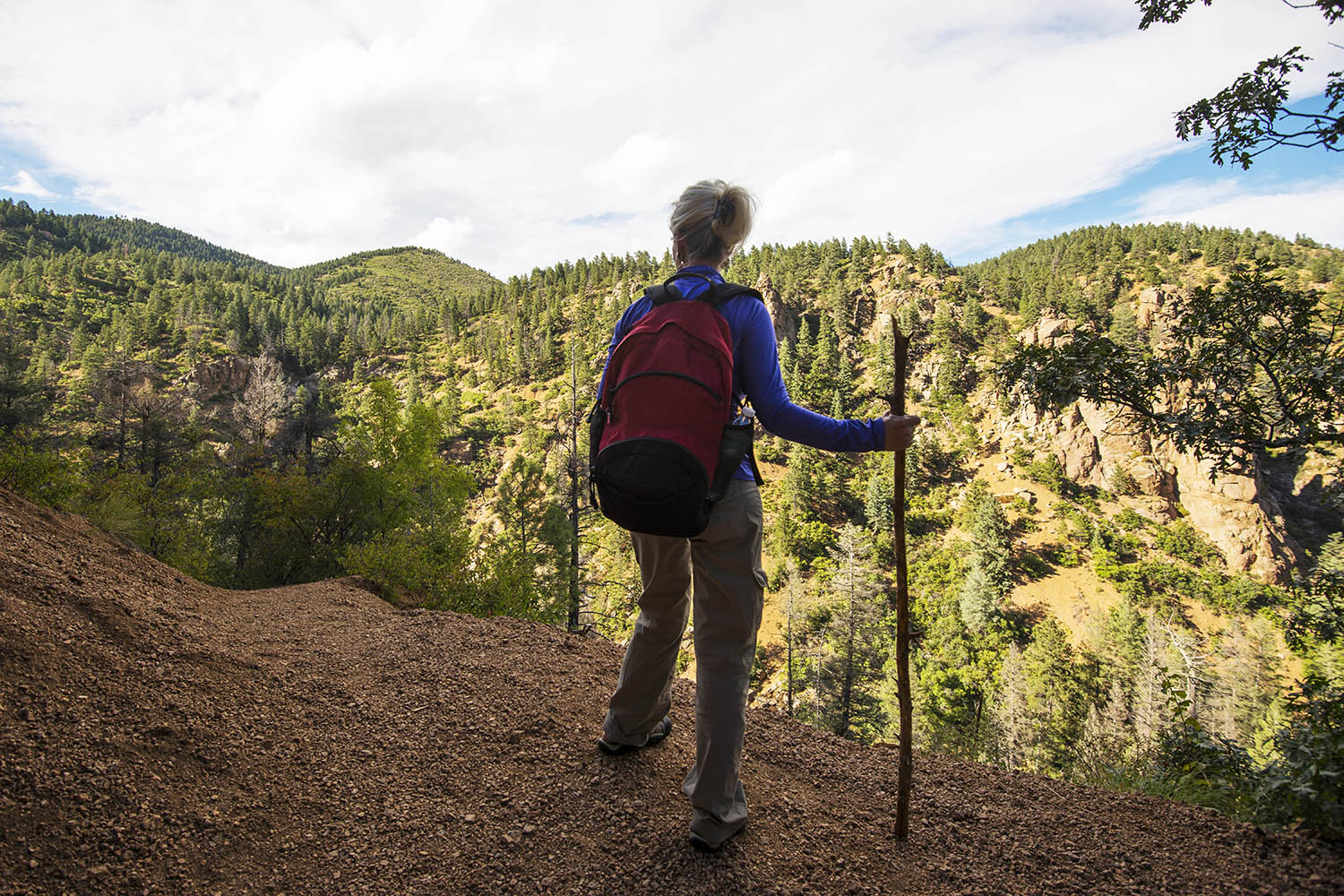 Female hiker with backpack overlooking valley