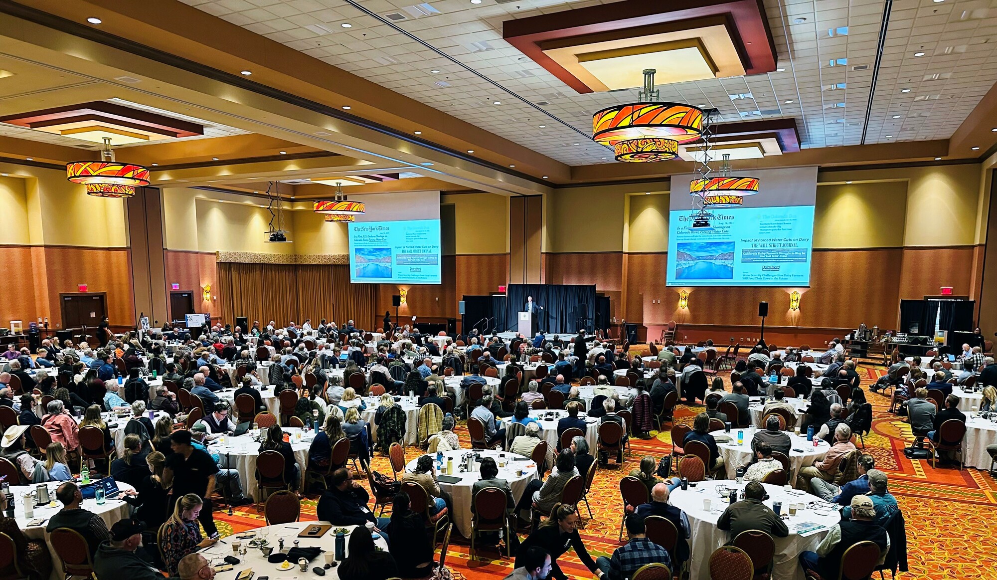 People seated at round tables at Fall Water Symposium 2023