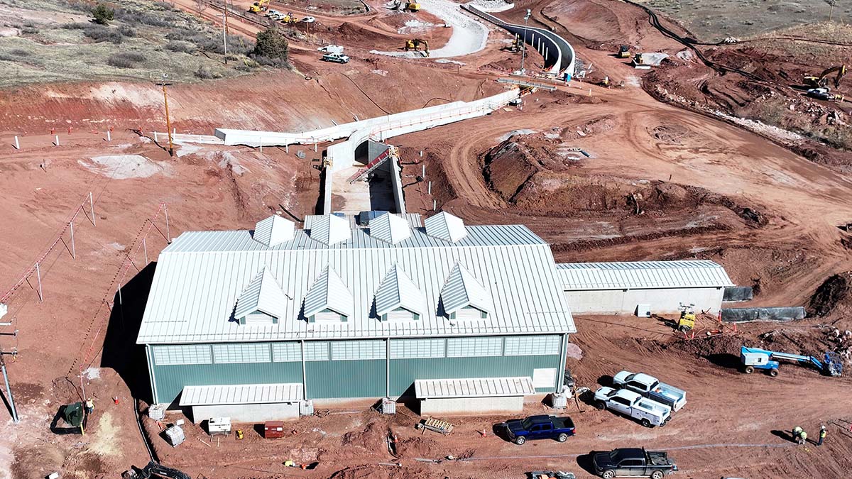 Metal building surrounded by construction activity