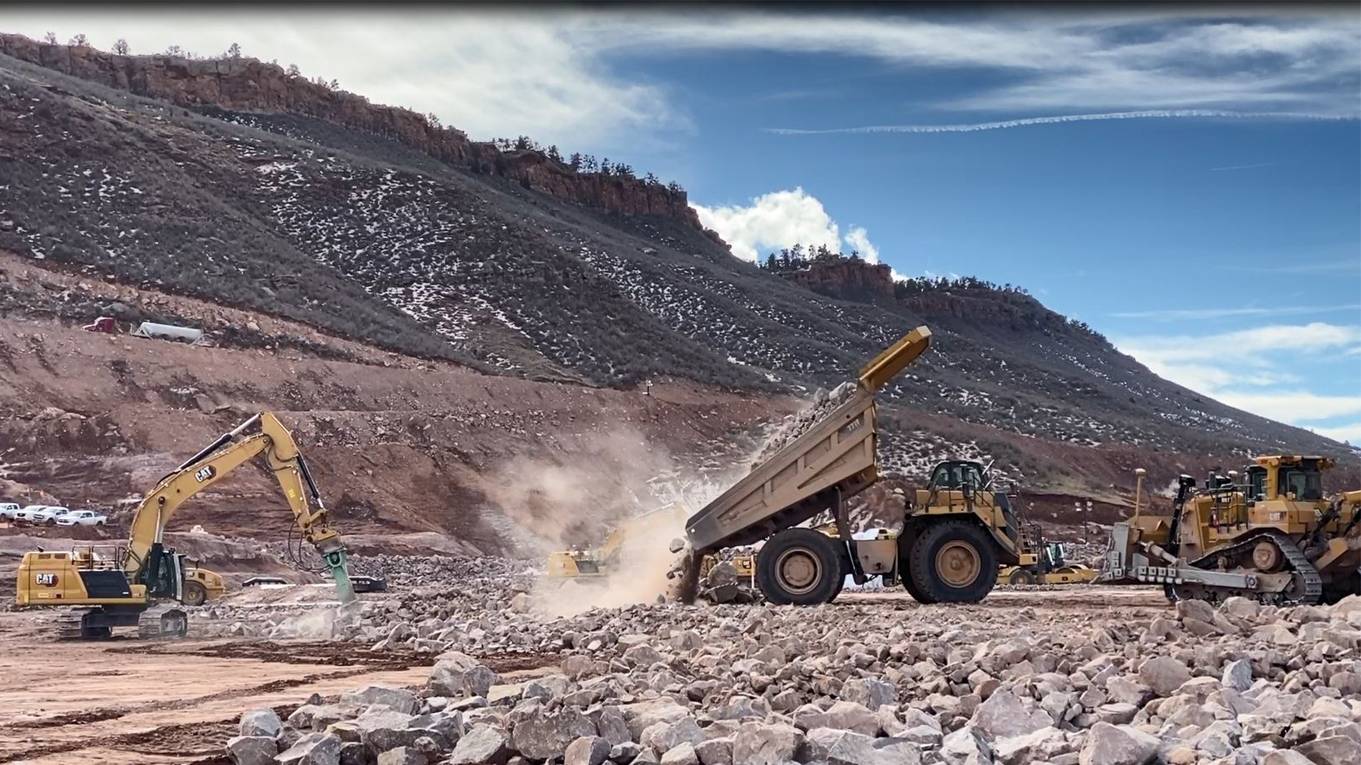 Truck dumping rockfill on the main dam at Chimney Hollow