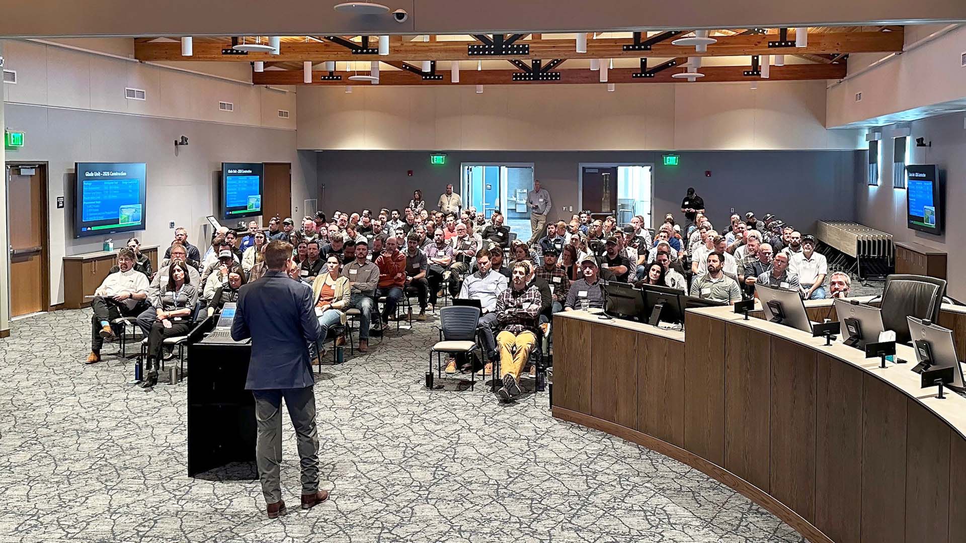 Person at podium in front talking to a room full of contractors.