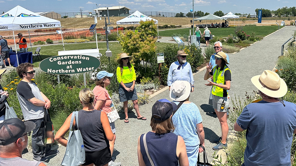 Girl giving a garden tour to a group.
