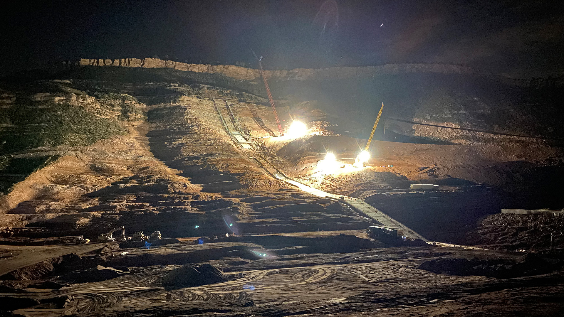 Crews working at night on the right abutment of the main dam. 