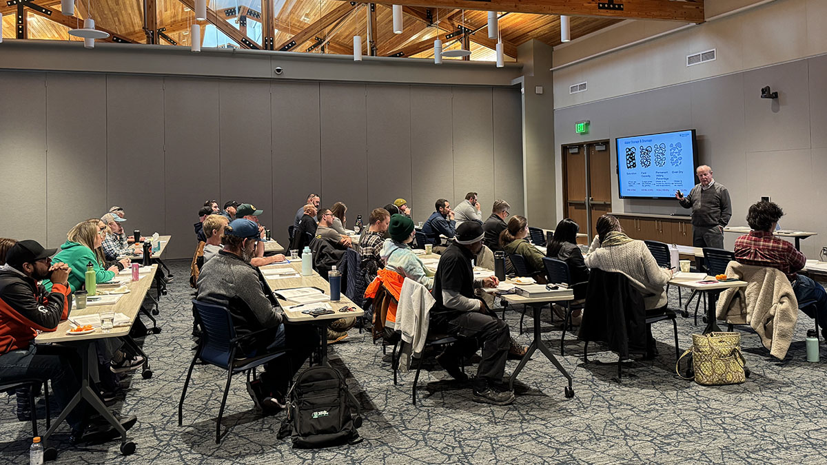 A group of people gather in a classroom setting for irrigation and landscape training