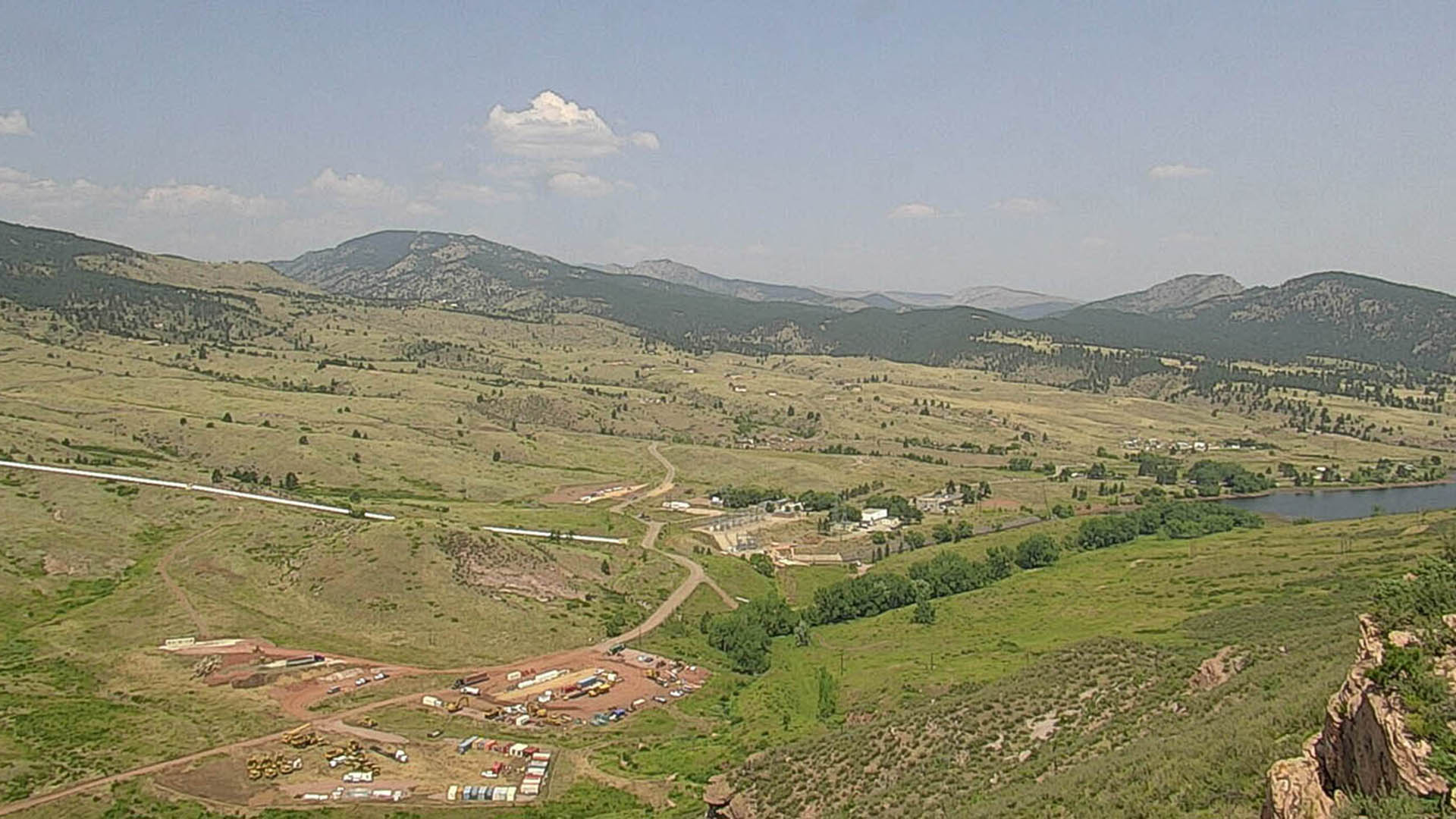 Valley nestled into foothills with the start of a construction project. 