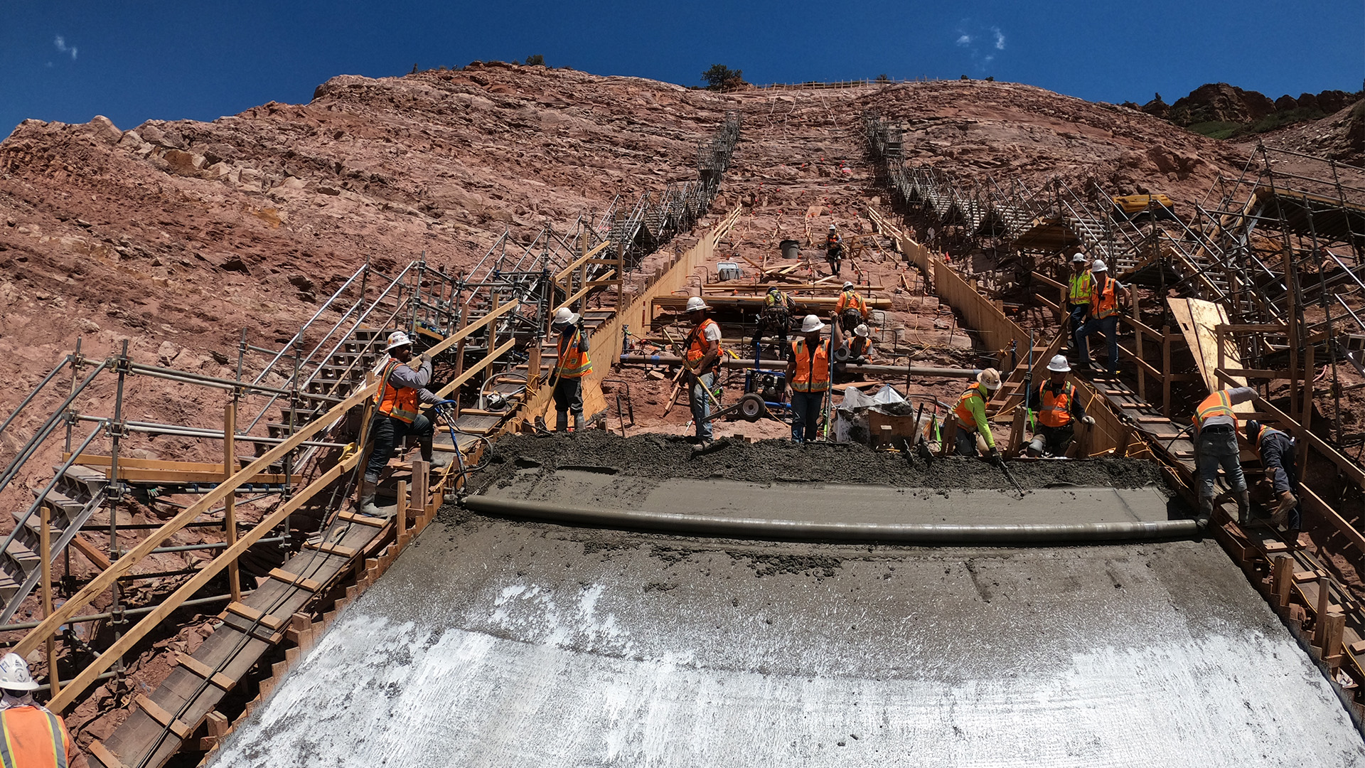 Crews pour concrete on a steep section of the plinth on the right abutment. 