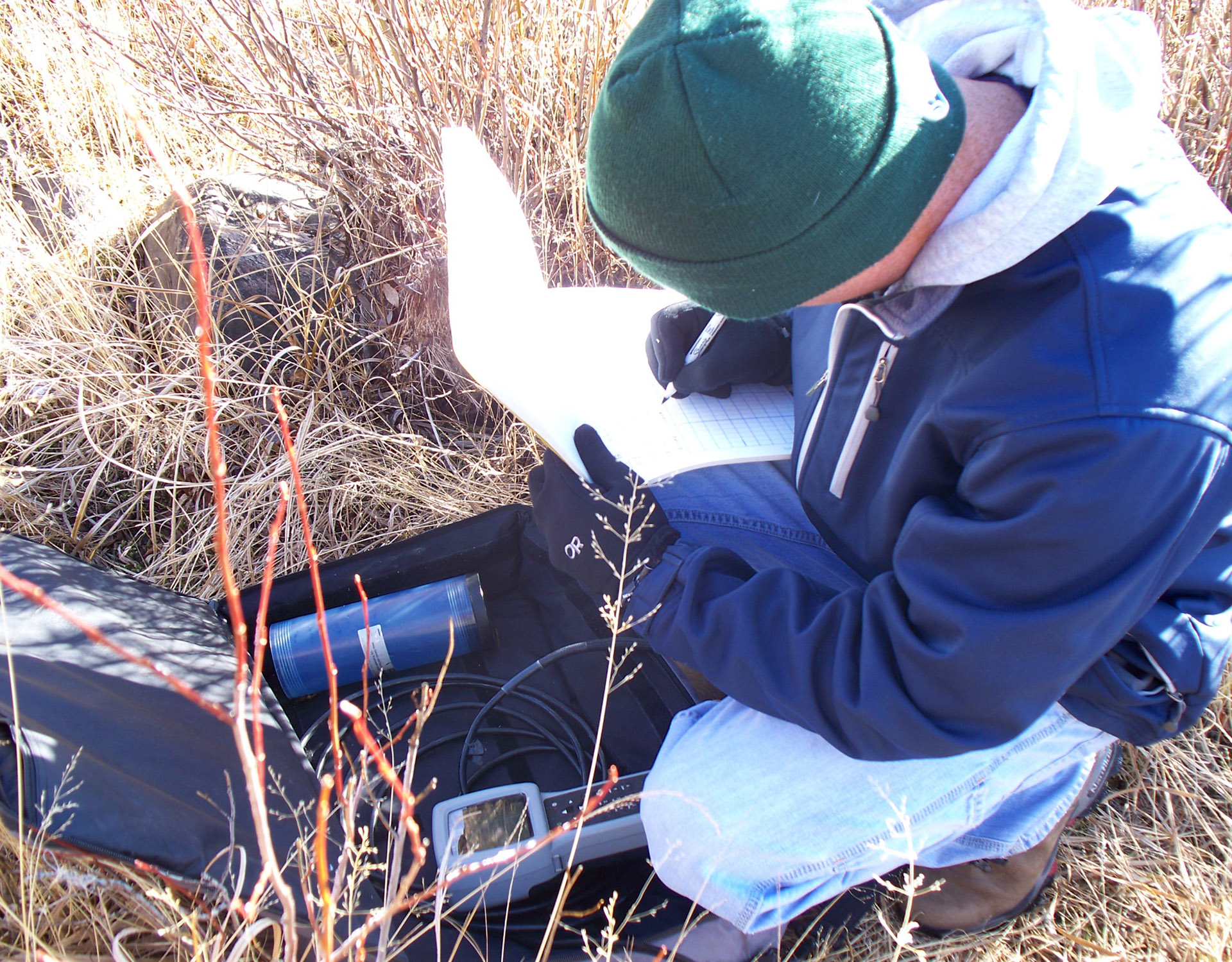 Employee writing results of water quality testing.