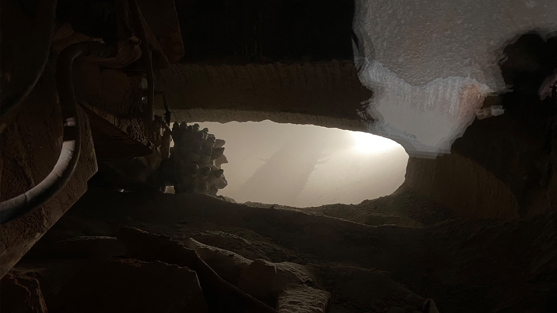 Roadheader cut through from the upstream portion of the tunnel into the downstream portion of the tunnel.