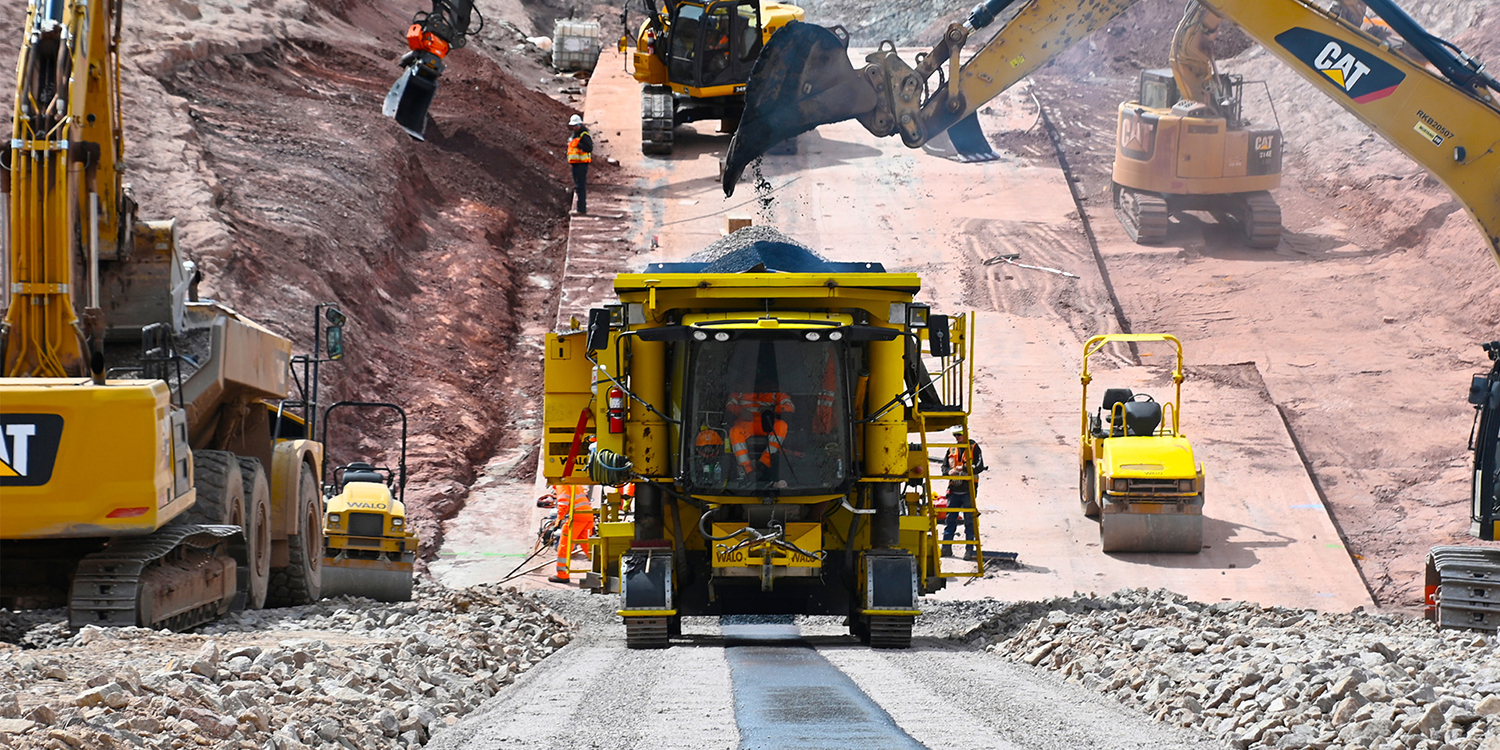 The asphalt core paver being loaded with asphalt.