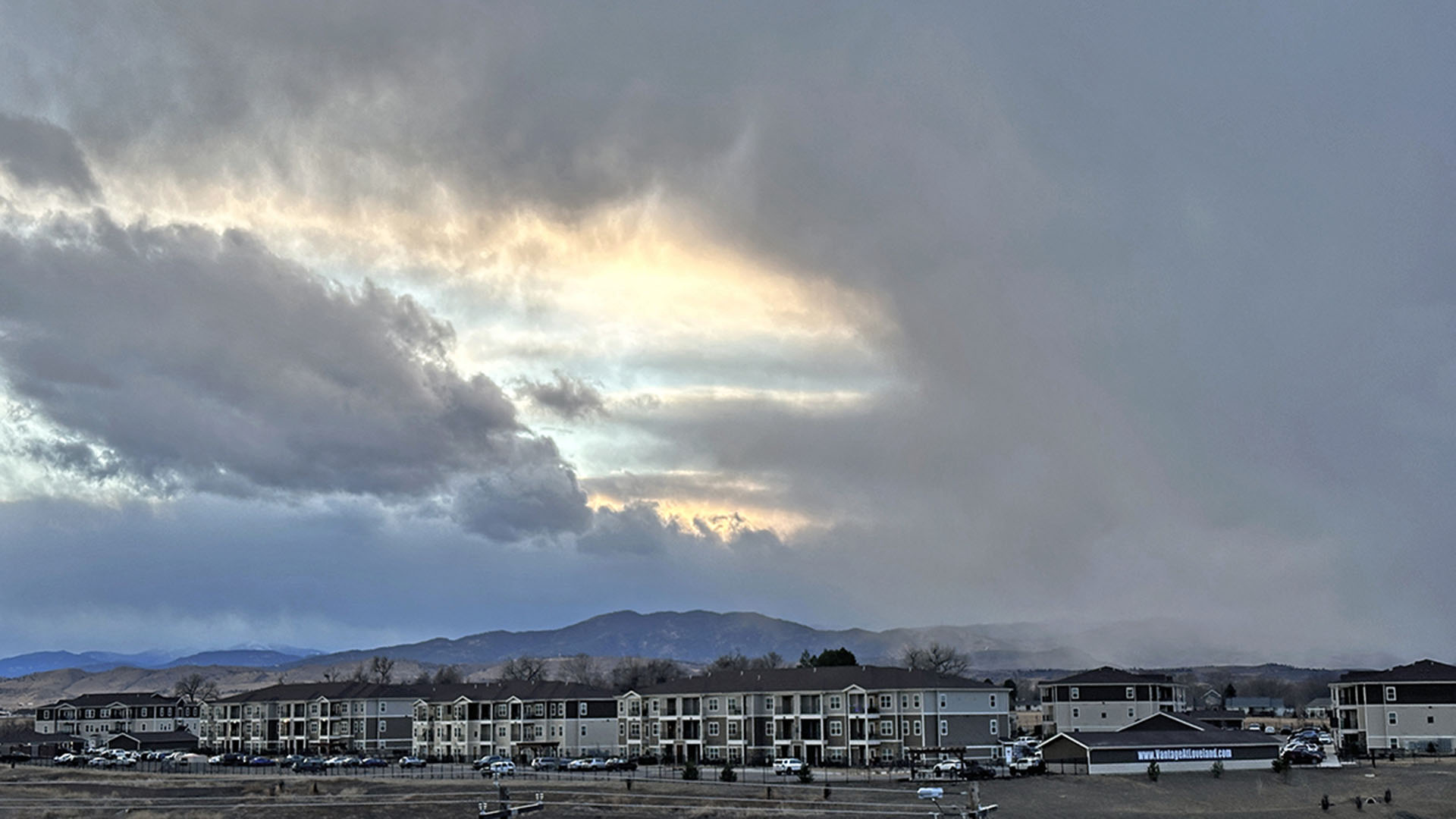Dark clouds appearing above apartments.
