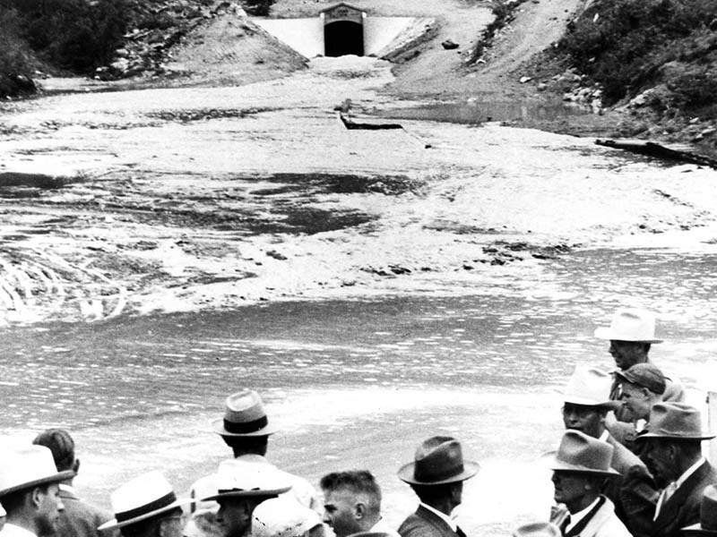 Group of people watch water flow through the Adams Tunnel for the first time on June 23, 1947.