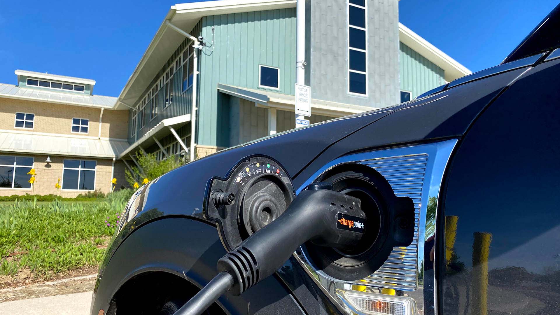 Vehicle plugged into an electric vehicle charging station.