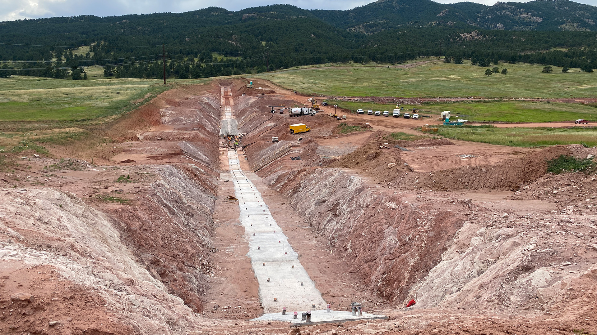 Saddle dam grout cap