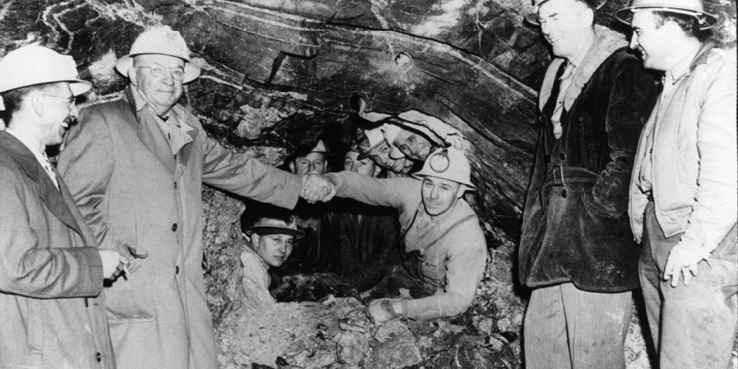 Crews working from both the West and East slopes hole through the Continental Divide Tunnel. NBC radio broadcasts the event live to the nation. A check of the center line and grade reveals the two sides are off by only a penny's width.