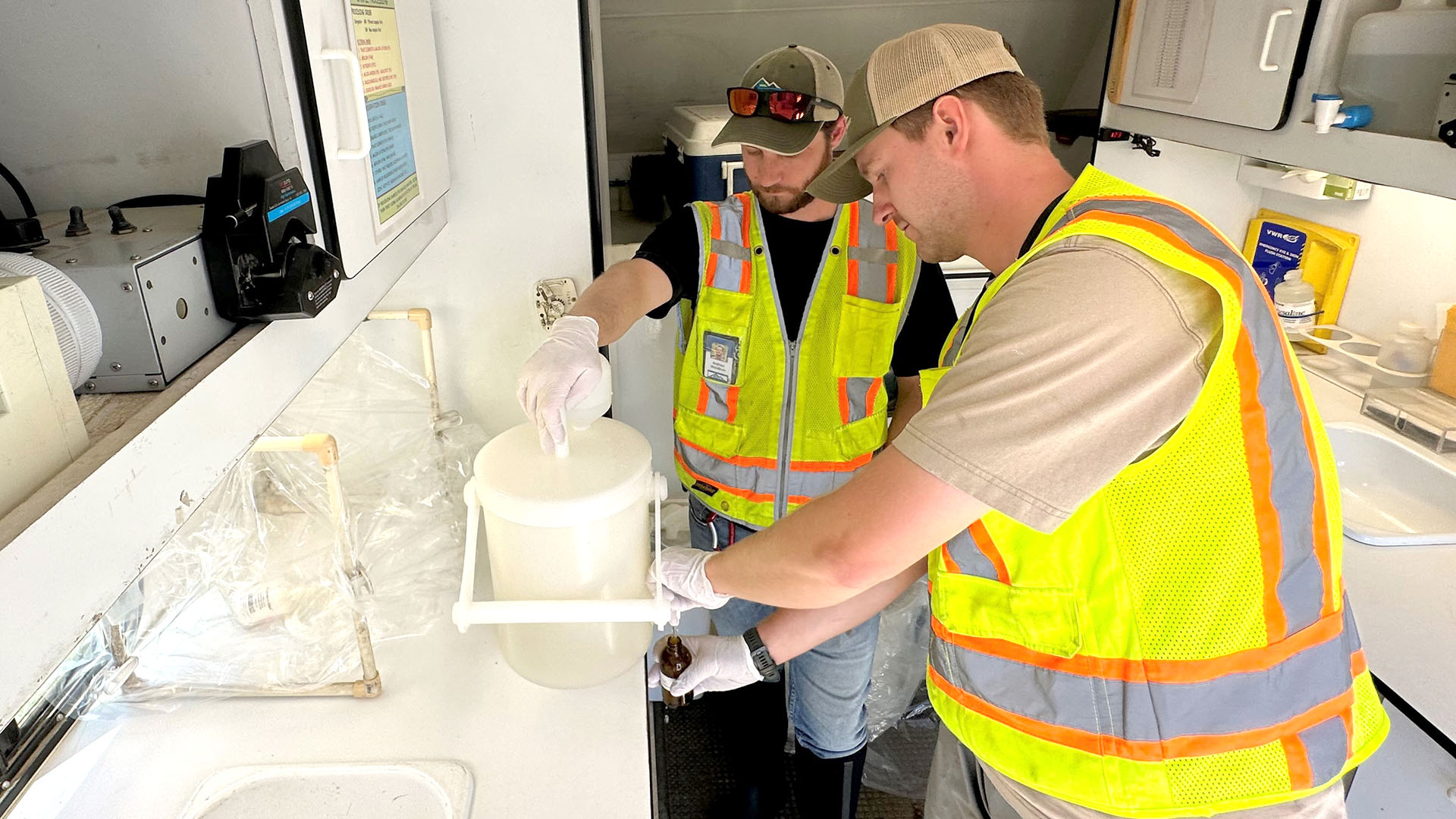 Two men conducting water sampling data.