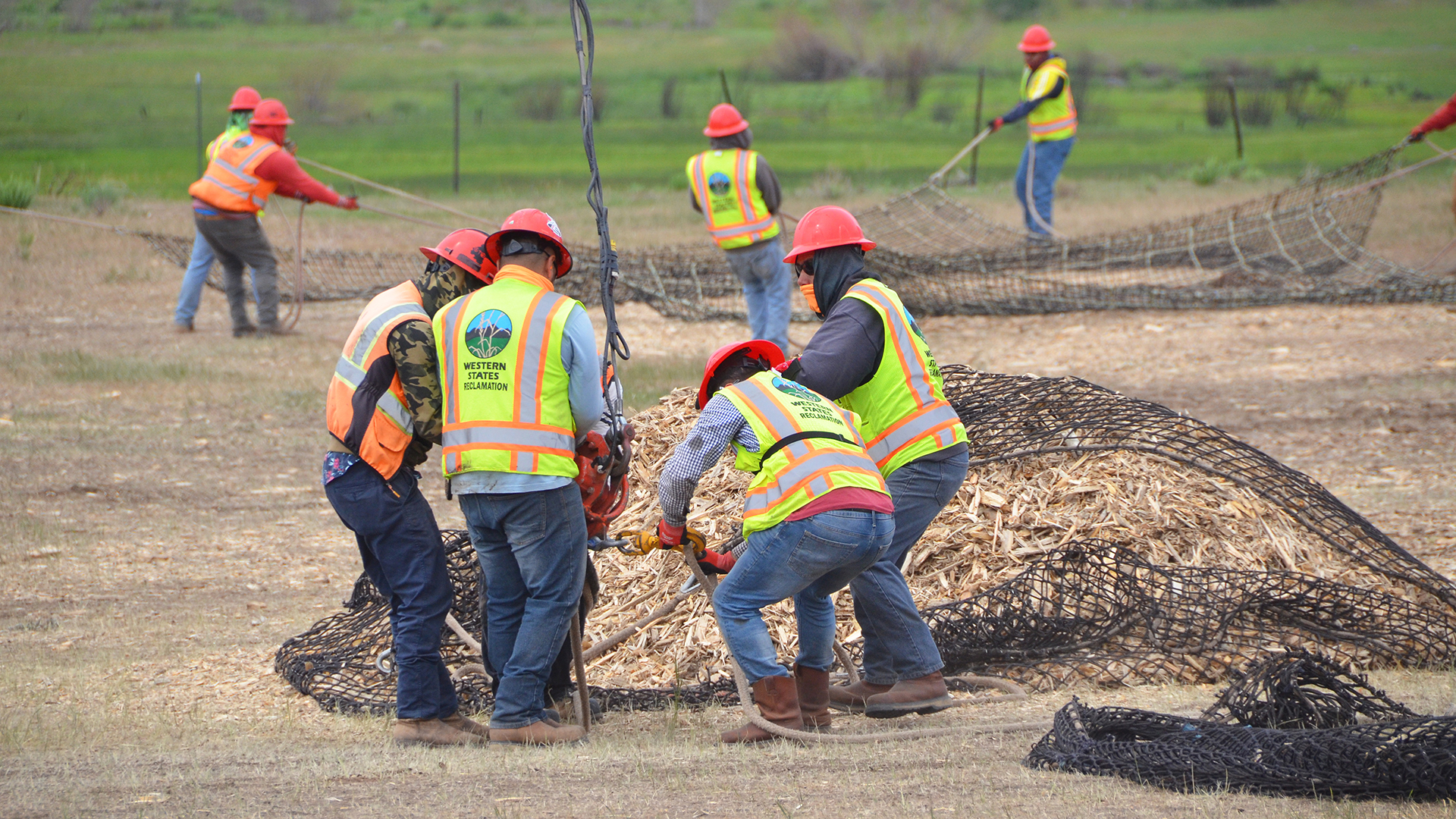 Crews filling mulch piles for aerial drops. 
