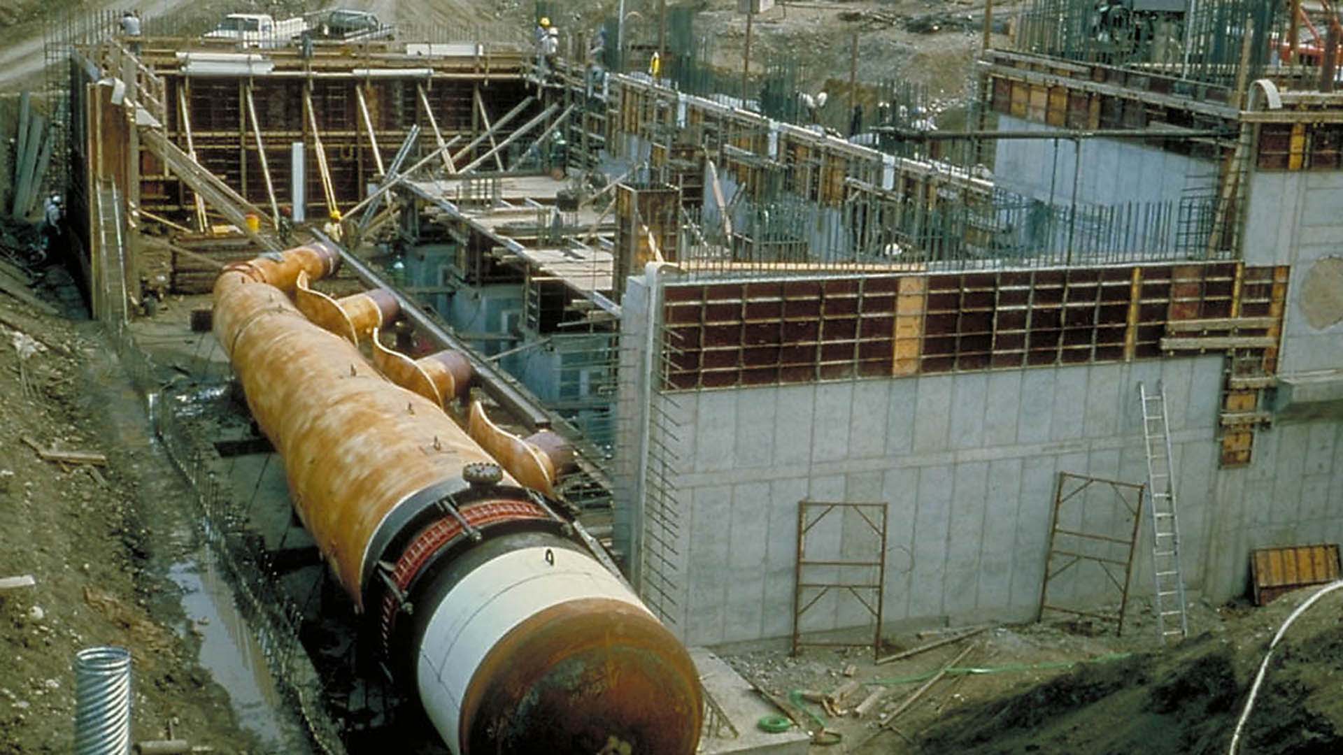 Construction of the Windy Gap Pump Plant with a pipe next to the building.
