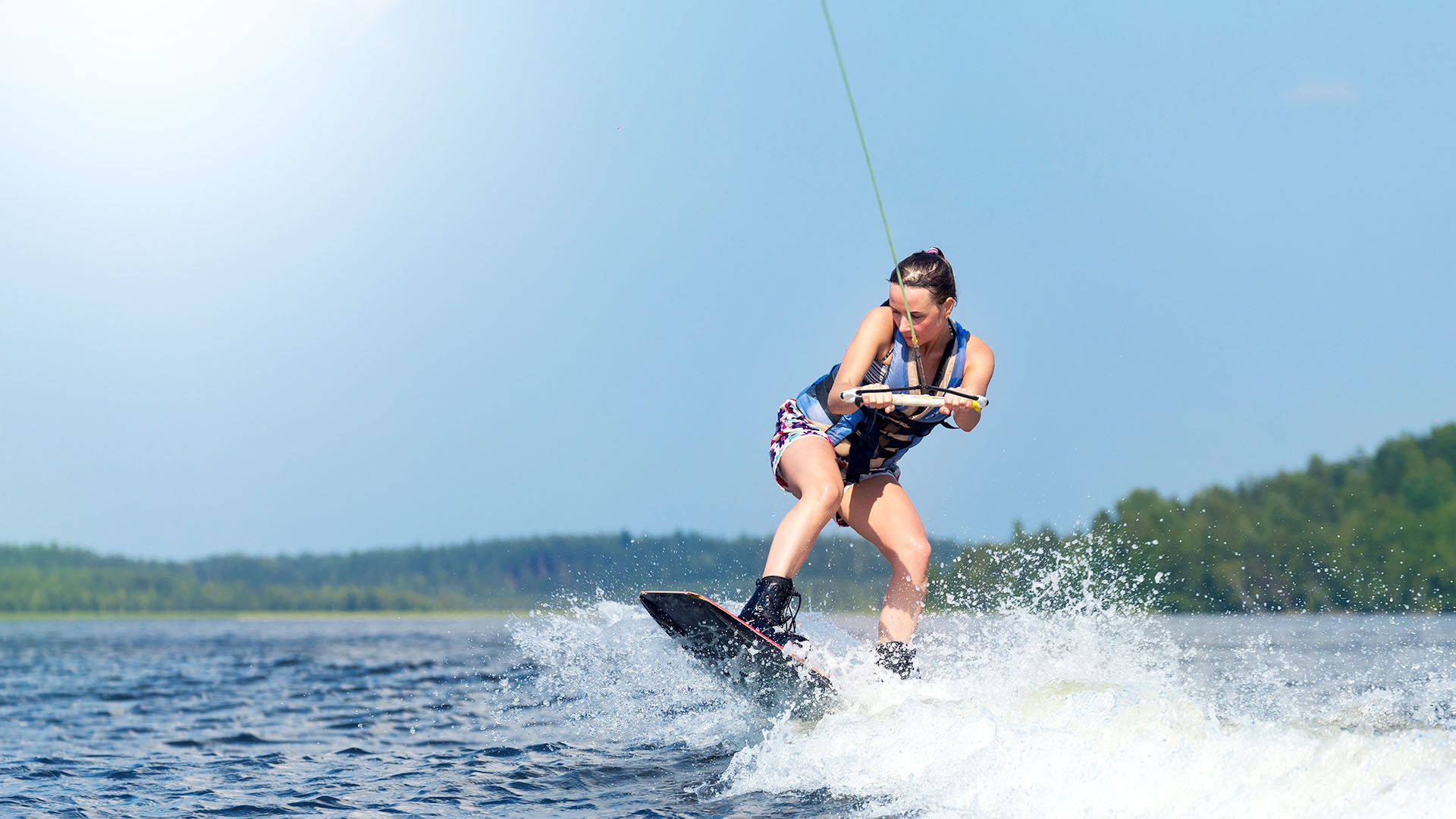 Woman on a wakeboard on the water. 