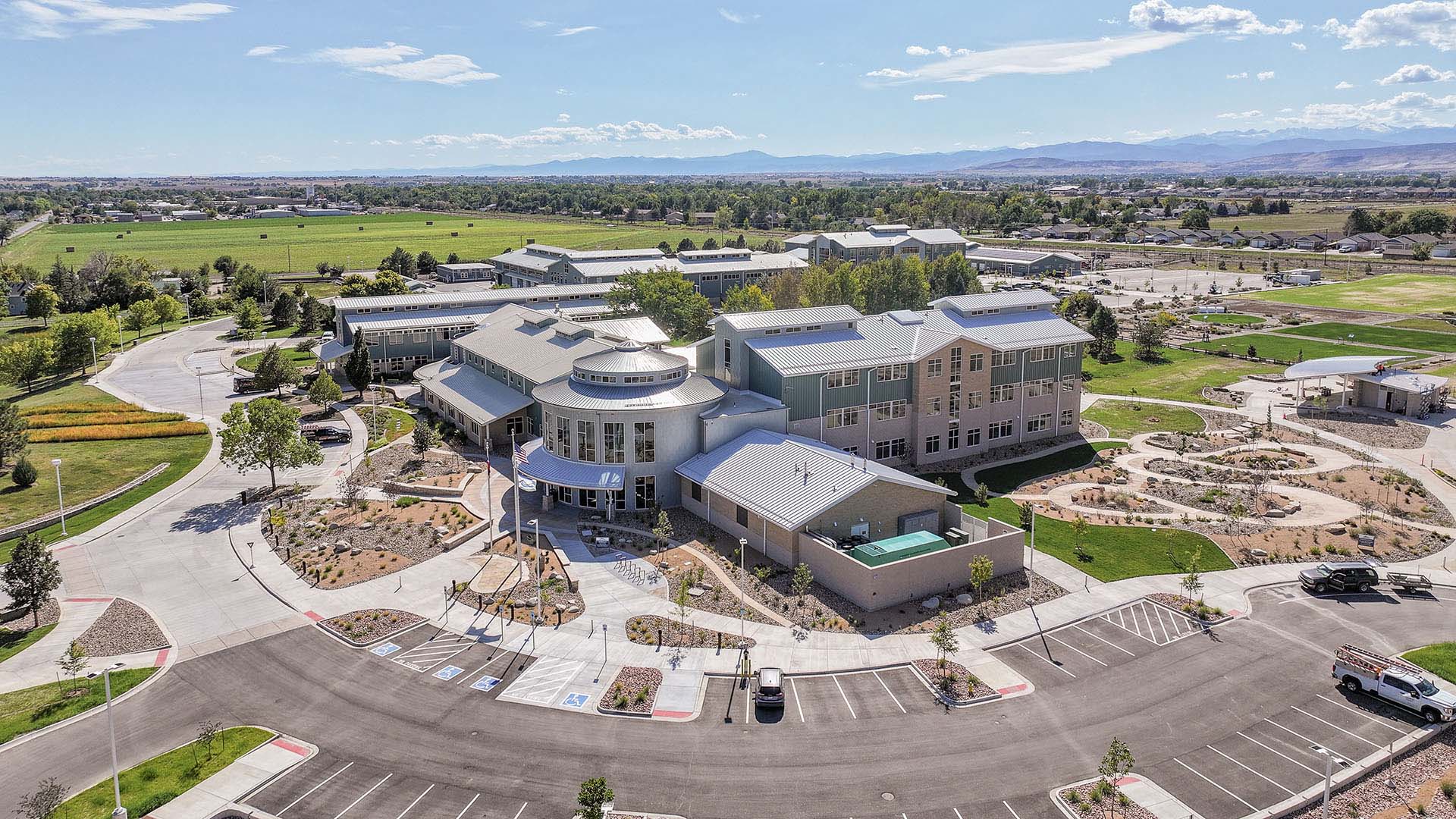 Aerial image of Northern Water Berthoud Campus with multiple buildings, parking lots, gardens.
