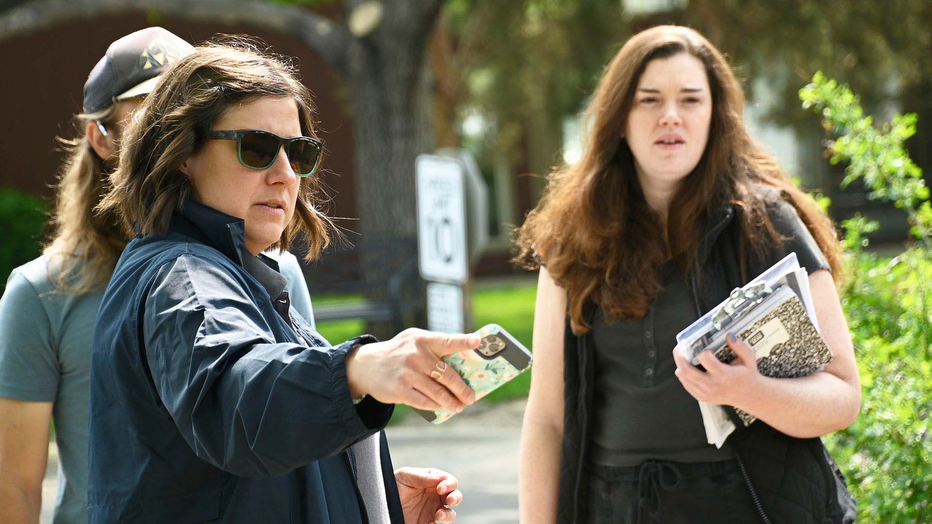Women pointing at landscape during a consultation as 2 people look on. 